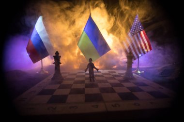 War between Russia and Ukraine, conceptual image of war using chess board, soldiers and national flags on the background of explosion. Ukrainian and Russian crisis. Selective focus