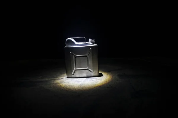 Metallic Fuel container. Canister for gasoline, diesel gas.Fire resistant storage tank on dark with backlight. Selective focus