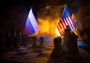 War between Russia and Ukraine, conceptual image of war using chess board, soldiers and national flags on the background of explosion. Ukrainian and Russian crisis. Selective focus