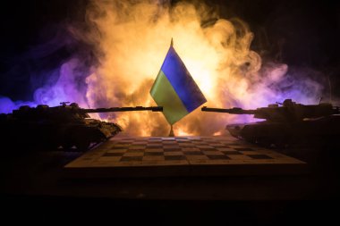 War between Russia and Ukraine, conceptual image of war using chess board and national flags on the background of explosion. Ukrainian and Russian crisis, political conflict. Selective focus