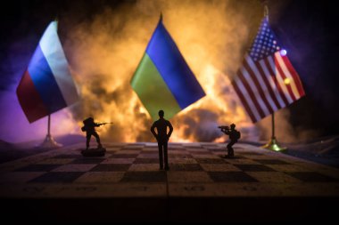 War between Russia and Ukraine, conceptual image of war using chess board, soldiers and national flags on the background of explosion. Ukrainian and Russian crisis. Selective focus