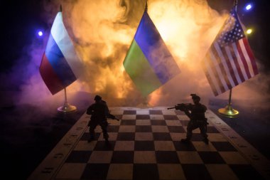 War between Russia and Ukraine, conceptual image of war using chess board, soldiers and national flags on the background of explosion. Ukrainian and Russian crisis. Selective focus