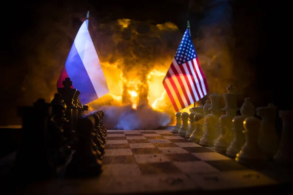 War between Russia and Ukraine, conceptual image of war using chess board, soldiers and national flags on the background of explosion. Ukrainian and Russian crisis. Selective focus