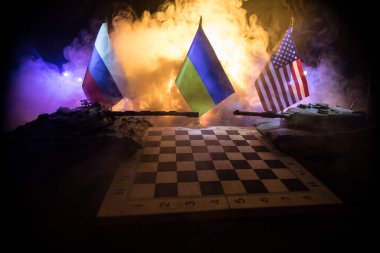 War between Russia and Ukraine, conceptual image of war using chess board and national flags on the background of explosion. Ukrainian and Russian crisis, political conflict. Selective focus