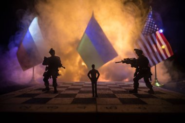 War between Russia and Ukraine, conceptual image of war using chess board, soldiers and national flags on the background of explosion. Ukrainian and Russian crisis. Selective focus