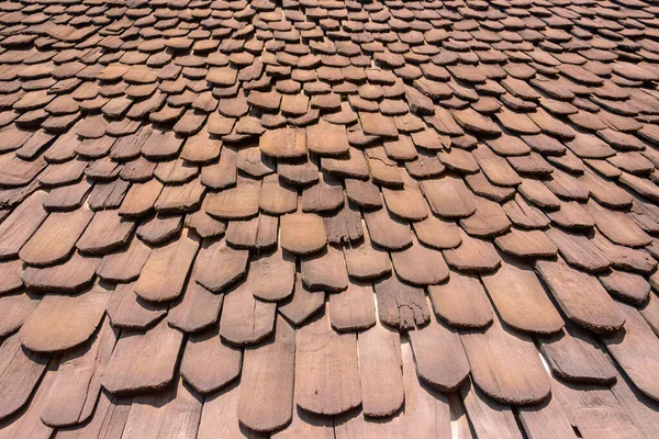 Closeup view of beautiful pattern and layer on the house's roof in the public place that is made from wooden. Warm tone.
