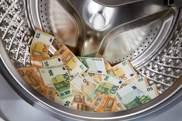 Tvätt av smutsiga pengar euro i tvättmaskin, närbild — Stockfoto