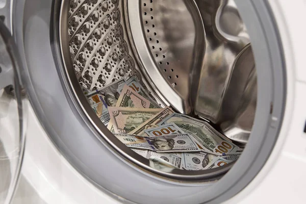 Money in washing machine, closeup. Money washing and laundering