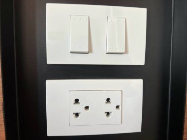 light switch and plug socket for appliance on the house wall