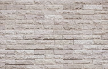 Krema ve bej tuğla duvar dokusu arka plan. Tuğla işçiliği ve taş döşeme döşeme eski kaya deseni temiz beton şebeke düz olmayan tuğla ofis tasarımı. Eski model tuğla duvar arkaplanının arka planı
