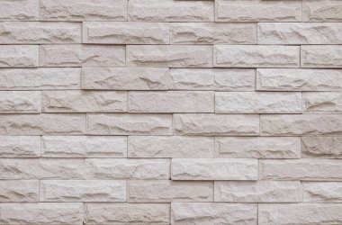 Krema ve bej tuğla duvar dokusu arka plan. Tuğla işçiliği ve taş döşeme döşeme eski kaya deseni temiz beton şebeke düz olmayan tuğla ofis tasarımı. Eski model tuğla duvar arkaplanının arka planı