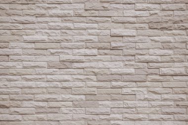Krema ve bej tuğla duvar dokusu arka plan. Tuğla işçiliği ve taş döşeme döşeme eski kaya deseni temiz beton şebeke düz olmayan tuğla ofis tasarımı. Eski model tuğla duvar arkaplanının arka planı