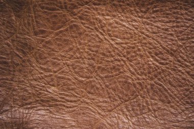 Kahverengi deri kaplama. Hakiki deri dokusu arka planı. Koyu kahverengi, turuncu desenler dekorasyon için boş. Tasarım çizgisi desenli klasik cilt doğal süet veya kırmızı soyut duvar kağıdı veya arka plan lüks etkinliği kullanılabilir.