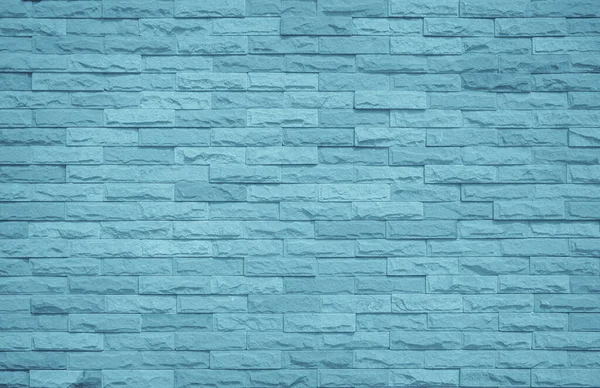 Brick wall painted with pale blue paint pastel calm tone texture background. Brickwork and stonework flooring interior rock old pattern clean concrete grid uneven bricks design stack backdrop.