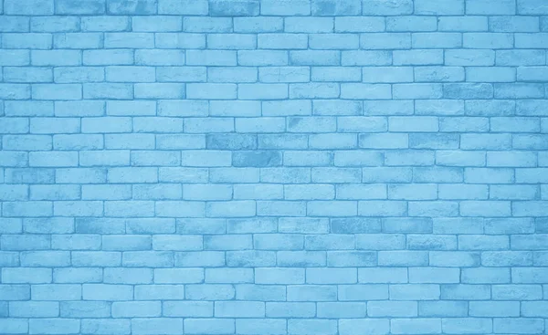 Brick wall painted with blue dark paint pastel calm tone texture background. Brickwork and stonework flooring interior rock old pattern clean concrete grid uneven bricks design stack backdrop.