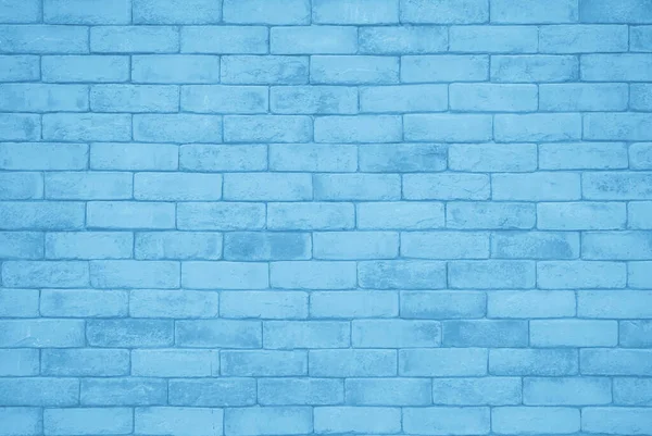 Brick wall painted with blue dark paint pastel calm tone texture background. Brickwork and stonework flooring interior rock old pattern clean concrete grid uneven bricks design stack backdrop.