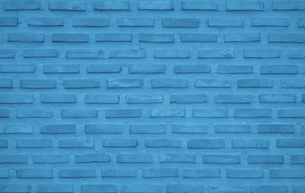 Brick wall painted with pale blue paint pastel calm tone texture background. Brickwork and stonework flooring interior rock old pattern clean concrete grid uneven bricks design stack backdrop.
