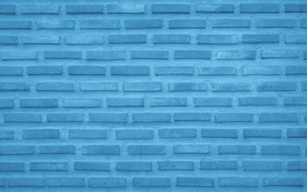 Brick wall painted with pale blue paint pastel calm tone texture background. Brickwork and stonework flooring interior rock old pattern clean concrete grid uneven bricks design stack backdrop.