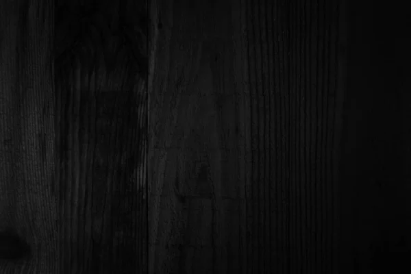 Dark aged & scratched Wood Textures. Dark black wood texture background viewed from above. The wooden planks are stacked. Black vintage painted wooden boards wall antique old background. Grunge dark texture. Painted weathered peeling table hardwood.