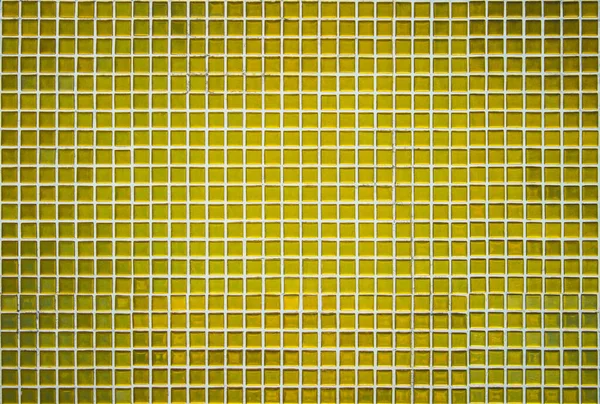 Gold yellow square mosaic tiles for ceramic wall and floor texture background in bathroom. Design golden pattern geometric with grid wallpaper decoration pool. Glass glitter seamless abstract surface.