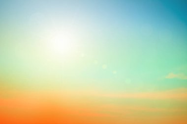 Abstract blurred sunlight beach colorful blurred bokeh background with retro effect autumn sunset sky have blue bright, white, and color orange calm. Blur gradient sunset background on soft nature sunrise  outdoor. Abstract evening clouds blur.
