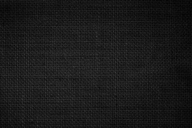 Black fabric canvas texture background. Linen dyed black. Sackcloth woven texture pattern background dark black color pipe from plant blade natural. Abstract vintage textured empty.