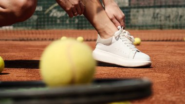 The girl corrects her sneakers before starting a workout