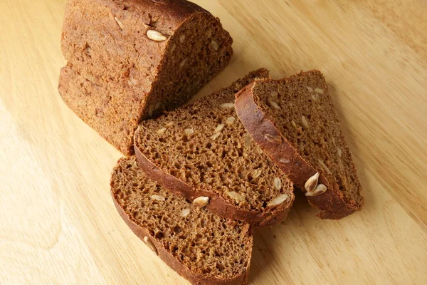 Bread with sunflower seeds on the board — Stock Photo, Image