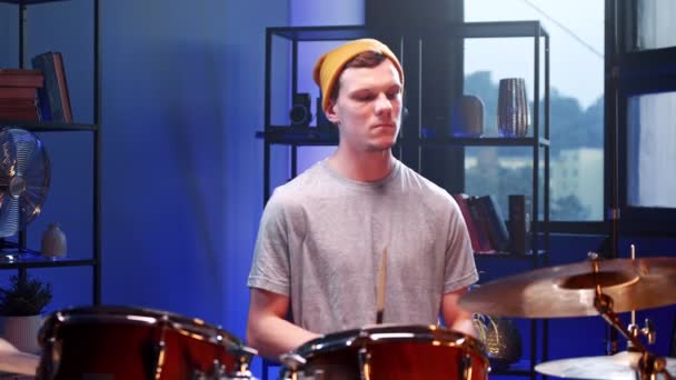 Drummer. Waist up portrait view of the young man sitting at the hi hat and drum kit and aggressively playing at the repetition — Stock Video