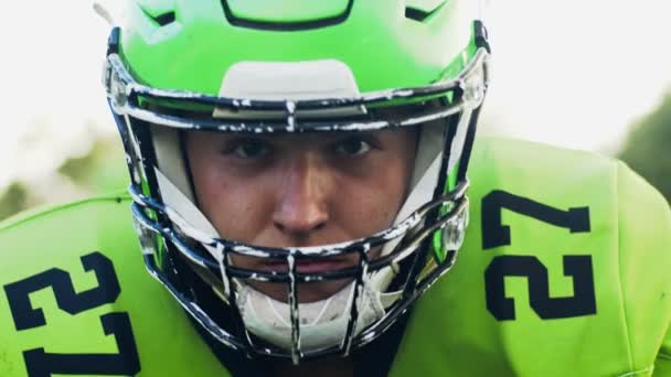 Portrait of confident professional American football player in helmet looking straight to camera ready for game. Man in uniform. Extreme sport concept — Stock Video