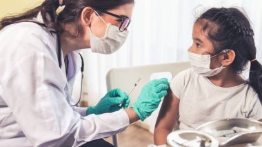 Liseli kız, aşı için yetenekli doktoru hastanede ziyaret ediyor.