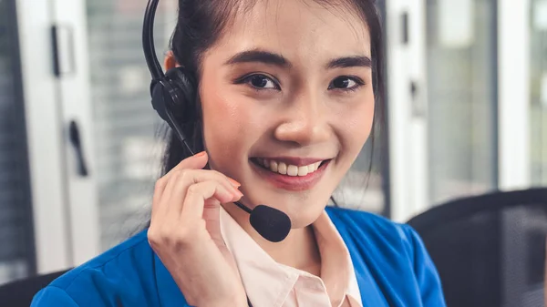 Businesswoman wearing headset working actively in office — Stock Photo, Image