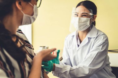 Genç bayan, aşı için yetenekli doktoru hastanede ziyaret ediyor.