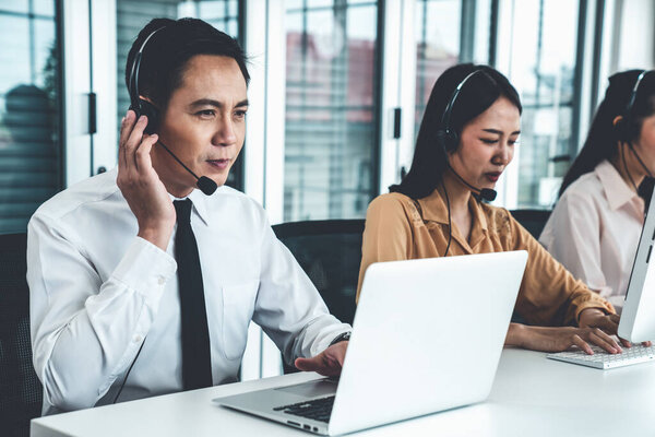 Business people wearing headset working actively in office