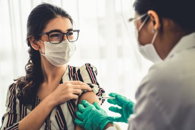 Genç bayan, aşı için yetenekli doktoru hastanede ziyaret ediyor.