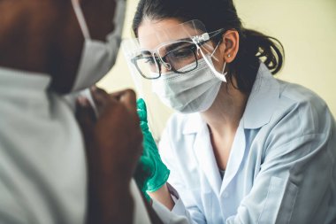 Genç adam, aşı için yetenekli doktoru hastanede ziyaret ediyor.