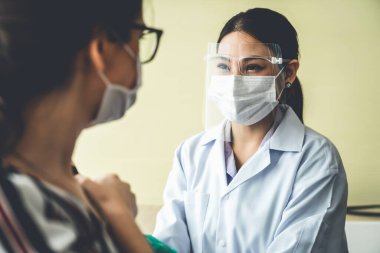 Genç bayan, aşı için yetenekli doktoru hastanede ziyaret ediyor.