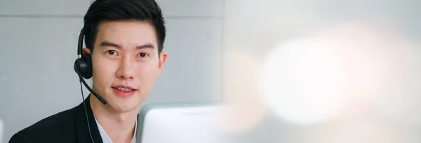 Business people wearing headset working in office in widen view — 图库照片
