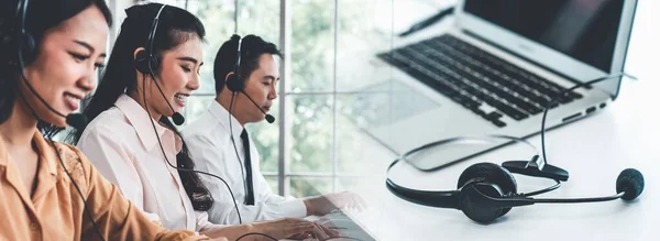Business team wearing headset working actively in office — Stock Photo, Image