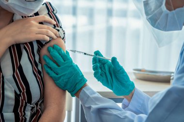 Genç bayan, aşı için yetenekli doktoru hastanede ziyaret ediyor.