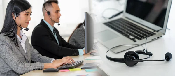 Business people wearing headset working in office broaden view