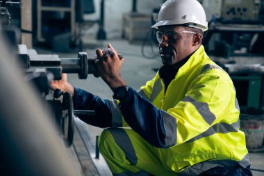 Fabrika işçisi veya mühendisi usta imalat atölyesinde makine işi yapıyor