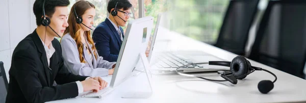 Business people wearing headset working in office in widen view — Stock Photo, Image