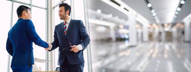 Business people handshake in corporate office in widen view