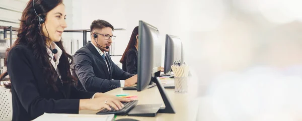 Business people wearing headset working in office broaden view