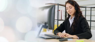 Ofiste çalışan kulaklık takan işadamları uzak müşteri ya da meslektaşlarını desteklemek için çalışıyorlar. Çağrı merkezi, tele pazarlama, müşteri destek acentesi geniş görünümde hizmet sunar .