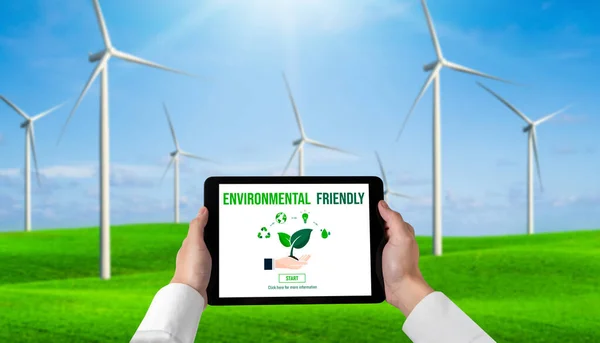 Green business transformation for environment saving and ESG business concept. Businessman using tablet to set corporate goal toward environmental friendly management and alternative clean energy use.