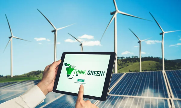 Green business transformation for environment saving and ESG business concept. Businessman using tablet to set corporate goal toward environmental friendly management and alternative clean energy use.