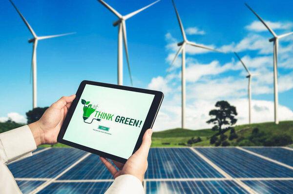 Green business transformation for environment saving and ESG business concept. Businessman using tablet to set corporate goal toward environmental friendly management and alternative clean energy use.