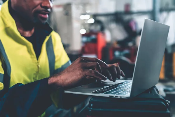 Factory worker working with laptop computer to do adept procedure checklist . Factory production line operator occupation quality control concept .